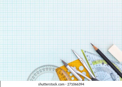 drawing tools on blue graph paper with copy space