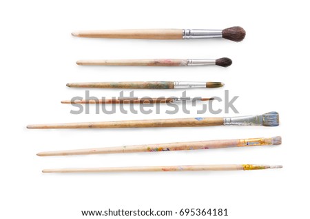 Drawing tools, set of dirty paint brushes in row on white isolated background, copy space, top view