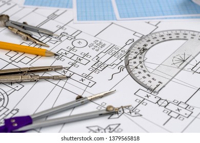 Drawing tools at technical sketch on table close up