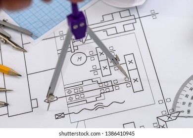 Drawing tools at technical sketch on table close up