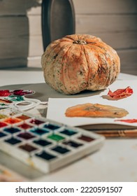 Drawing in watercolor in sketchbook  Autumn still life and pumpkin   red leaf  Learning to draw at home  Creating content concept 