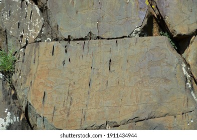 Drawings of ancient people on the rocks - petroglyphs in the mountains of the Altai Republic - Shutterstock ID 1911434944