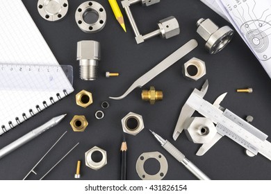 Drawings, Components And Design Tools On The Table Of An Engineer Or Designer Illustrating Research And Development Process In Engineering And Science. 