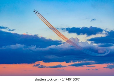 Drawings of smoke in the sky made from airplanes at a airshow demonstration.