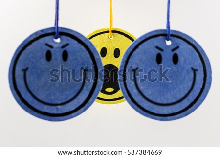 Drawn faces (blue and yellow) hanging on strings representing being in danger