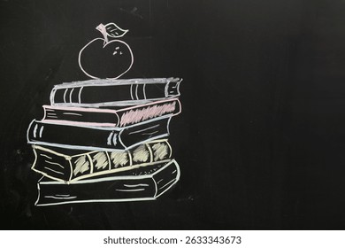 Drawn stack of books and apple on chalkboard