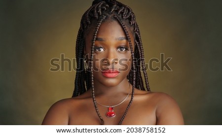 Dreads style close-up portrait of beautiful black woman. Typical African style.