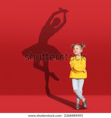 Dream about future occupation. Smiling girl and silhouette of ballerina on red background