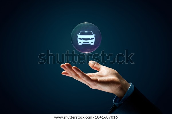 Dream about new car, carsharing, car rental and\
leasing concepts. Hand with soap bubble (symbol of dream) with\
symbol of the car inside.
