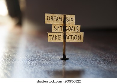 Dream Big, Set Goals, Take Action, concept, tags on the table.