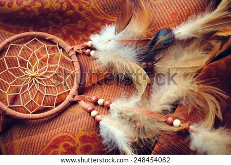 Dream catcher on red canvas