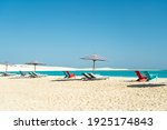 Dream paradise beach with umbrellas and chairs at the turquoise Mediterranean sea at El Alamein near Alexandria, Egypt