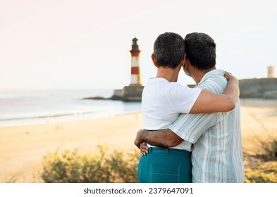 Dream Vacation. Rear View Of Mature Couple Embracing And Looking At Stunning Ocean View With Lighthouse, Standing Outdoor. Spouses Enjoying Romantic Holidays Moment. Copy Space - Powered by Shutterstock