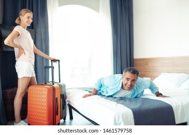 Dream vacation. Smiling married couple being happy finaly relaxing in their new hotel room. - Shutterstock ID 1461579758