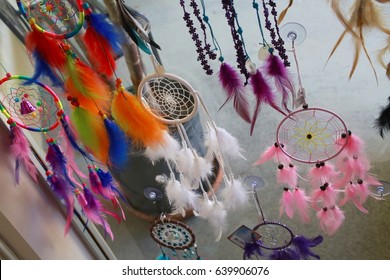 Dream Weaver Feather Designs In Various Colors Hanging In Window