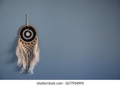 dreamcatcher hanging on the blue wall