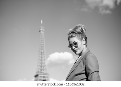 Dreaming about paris. Sexy woman at eiffel tower in paris, france on vacation. Woman in sunglasses on sunny blue sky outdoor. Girl with fashion look and sensual beauty. Travelling on summer vacation.