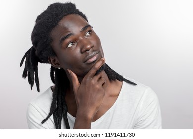 Dreaming African Man With Dreadlocks On White Background With Hands On Chin Or Chest Dreaming African Man With Dreadlocks On White Background With Hands On Chin Or Chest