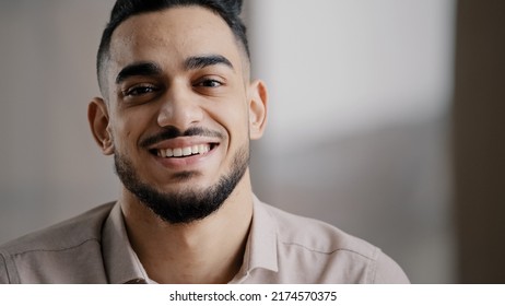 Dreaming Arabic Handsome Young Man Agent Worker Deep In Thoughts Look Away Turn Head At Camera Happy Male Human Face Friendly Businessman Millennial 20s Guy Smiling With Toothy Smile Close Up Portrait