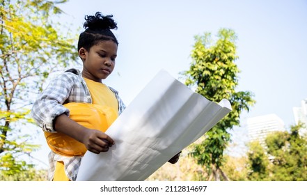 Dreaming engineering kid, Young boy with the idea of ​​becoming an engineer in the future. Passing on business to heirs. Roleplay in public park middle of public park. - Powered by Shutterstock