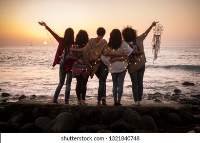 Dreaming image with group of females friends hug each other all together looking the sunset for friendship and love concept - Forever friends and dream lifestyle concept - people enjoying and feeling 
