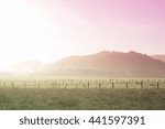 Dreamlike early morning scene of a farm and mountains with a pink and green neon filter applied. Ferndale, Humboldt County, California, USA.