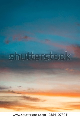 Dreamlike sunset gradient with soft, warm colors fading into a darker blue sky, accented by layers of wispy clouds