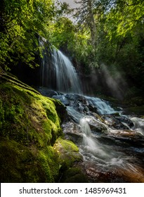 Dreamlike waterfall with moss covered rocks