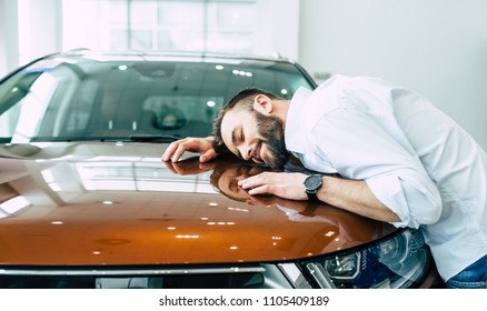 Dreams Come True Today. Happy Handsome Bearded Man Buying A Car In Dealership