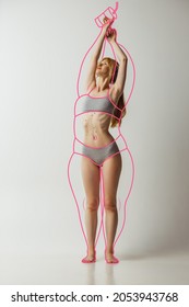Dreams or fears. Young beautiful slim woman in lingerie isolated over gray background. Drawings of junk food and overweight lines around body. Concept of healthy eating, dieting, weight loss and