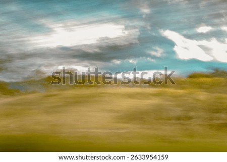 Dreamy abstract landscape with gentle motion blur, blue sky and golden fields. Impressionist fine art background, Andean region, Quindío, Quindio, Colombia