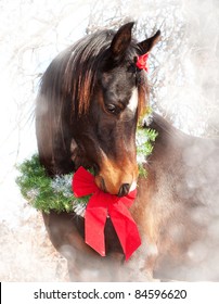 Dreamy Christmas image of a dark bay Arabian horse wearing a wreath and a bow