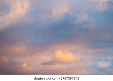 Dreamy cloud layers bathing in sunset light, soft pink and orange cast across low clouds, hazy atmosphere, cinematic twilight feeling for romantic or meditative projects