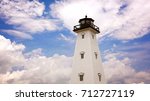 Dreamy lighthouse against cloud filled sky in Gulfport, Mississippi