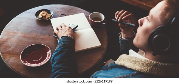 Dreamy Man In Headphones Working In Cafe. Smart Casual Dress