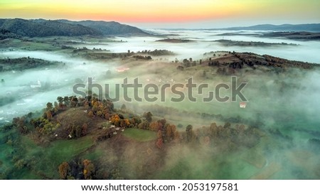 Dreamy mornings with mist engulfing the small village of Rohia and the surroundings, in the ancient region of Lapusului Land. Photo taken on 2nd of October 2021 in Rohia, Maramures County, Romania.