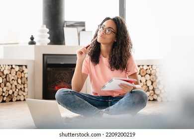 Dreamy Thoughtful Pensive Young Woman Author Student Doing Paperwork, Writing Poetry Novels At Home Using Laptop, Preparing For Test Exam