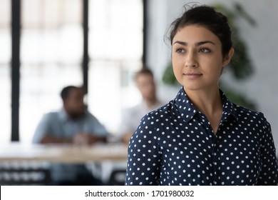 Dreamy Young Indian Female Employee Look In Distance Thinking Or Pondering, Thoughtful Happy Millennial Biracial Woman Worker Plan Consider Future Career Opportunities, Business Vision Concept