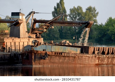 A dredger in working condition while extracting sand from the river bottom.