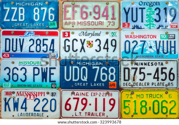 DREMPT, THE NETHERLANDS - OCTOBER\
1, 2015: Vintage car license plates on a wall in Drempt, The\
Netherlands. In the U.S. each state issues its own car number\
plates.