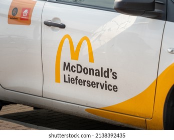 DRESDEN, GERMANY - 19. March 2022: McDonald's Delivery Service Logo On The Exterior Of A Car. Sign Printed On The Door Of The Restaurants Car. Ordering Fast Food To Your Home.