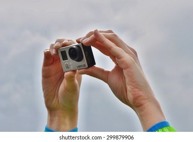 DRESDEN, GERMANY, 27.05.2015: Woman Holds Over Head Sport Camera Go Pro Hero 3 Used In Extreme Situations, 