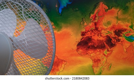 Dresden, Germany - July 21, 2022: Map Of Europe On Windy Weather Web Service Digital Map Showing Global Heatwave Of Extreme High Temperature And A Fan Trying To Cool It Down. Concept Of Global Warming