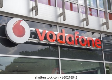 DRESDEN, GERMANY - JUNE 10, 2017: Vodafone Shop Sign, Company Based In The UK. It Provides Mobile Phone, DSL, LTE, Cable Internet, Landlines, Cable TV And IPTV Services To Customers In Germany.