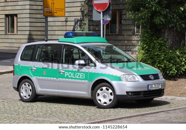 DRESDEN, GERMANY - MAY 10, 2018: Germany\
police Volkswagen Touran car parked in Germany. Saxony Regional\
Police (Landespolizei Sachsen) employs 13,900\
persons.