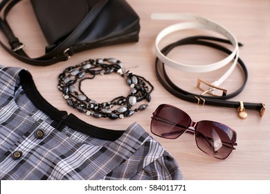 The dress and accessories. Handbag, sunglasses, belts and beads in harmony with the style and color of dress. Fashion and design clothes for women. Accessories and clothes create a style woman