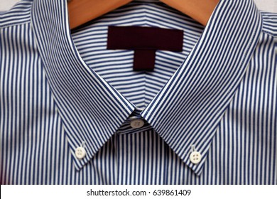 Dress Shirt On A Hanger With A Label For Copy Space - Close Up Detail.