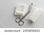 Dressing or clean wound tools includes Roll gauze,pile of gauzes and gauze roll cutter or scissors