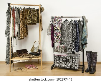 Dressing Closet With Animal Print Clothes Arranged On Hangers. Colorful Wardrobe With Jungle Pattern Clothes And Accessories.