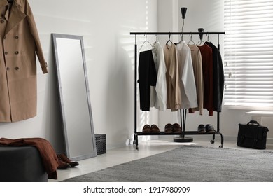 Dressing Room Interior With Clothing Rack And Mirror